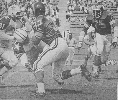 <p>Early 1960s NFL action! Members of the Los Angeles Rams defense move in to stop Amos Marsh of the Dallas Cowboys. The Cowboys were still in the days of their infancy (we think this is taken from the game in 1962 - a 27-17 Cowboy upset of the Rams). </p>
<p>The Rams were in the beginning stages of assembling that great and dominating defense that in just a few years would earn the nick-name of the Fearsome Foursome. By the mid-60s, with defensive lineman Lamar Lundy, Merlin Olsen, Rosey Grier and Deacon Jones, the Rams would become a defensive powerhouse. </p>
