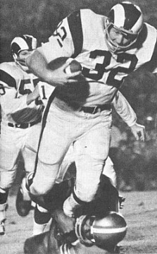 Ram Linebacker Jack Pardee returns an interception in classic NFL action. Pardee was a solid contributor to the dominating Rams defense of the 1960s. In his 13 years with Los Angeles he hauled in 17 interceptions with 4 of those going for touchdowns. He is also credited with 14 fumble recoveries during his time with the Rams. He was named to the Pro Bowl in 1963. 