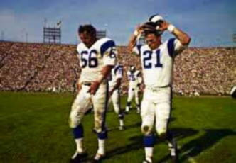 So many great names on those Los Angeles Rams defenses of late decade of the 1960s. Ranked in the NFL's Top 10 every year he was there as a starter. Here he walks to the sidelines accompanied by All-Pro Safety Ed Meador.