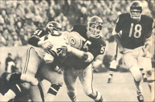 Early 1970s NFL - Packers runner John Brockington (#42) powers forward as Bears linebackers Dick Butkis (#51) and Doug Buffone (#55) wrap him up in an effort to bring him down. #18 of the Bears is safety Jerry Moore from Arkansas.