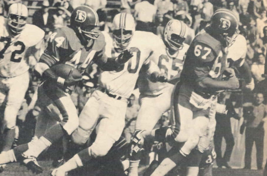Broncos runner Floyd Little gets behind George Goeddeke (#67) as he makes yardage against the Boston Patriots defense. Pictured for the patriots are Larry Eisenhauer (#72), Jim Cheyunski (#50) and Houston Antwine (#65).