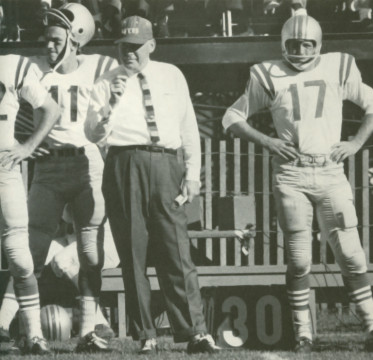 On the San Francisco 49er sideline during the early 1960s - Head coach Red Hickey between 2 of his tailbacks Bob Waters (#11) and Billy Kilmer (#17). 