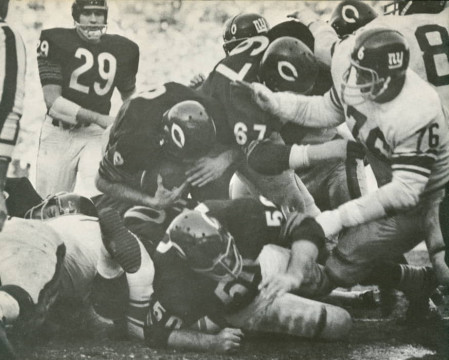 From the 1963 NFL Title game bewteen the New York and Chicago - QB Billy Wade gets behind the blocking of center Mike Pyle (#50) and guard Ted Karras (#67)to score on a 1 yard sneak and give the the Bears a 14-10 lead in the 3rd quarter. The score would stand throughout the rest of the game.    