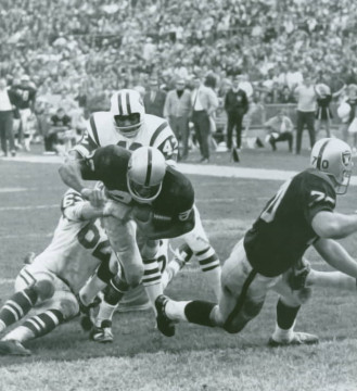 Raiders runner Charlie Smith breaks through Al Atkinson and Randy Beverly of the Jets in 1968