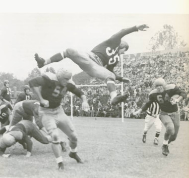 Packers return man Ted Fritisch returns a kick as Redskins player Wilbur Moore hurdles over Larry Craig during a 1945 NFL Preseason game
