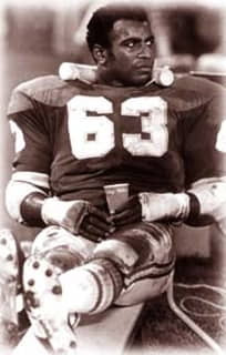 Willie Lanier recylining on a sideline bench during a game