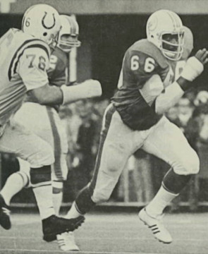 Dolphins Hall of Fame lineman Larry Little gets outside to lead-block with The Colts Fred Miller close behind. Quarterback Bob Griese can be seen in the backfield.