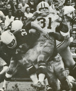 Pat Fischer of the Cardinals defense stops Jim Taylor of the Packers in 1963