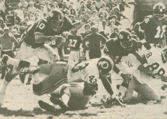 Brad Van Pelt leads the Giants defense in stopping Larry Brown of the Washington Redskins