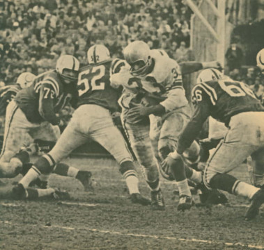 Lion Nick Pietrosante slips through the Colts defense for few yards. #52 is Dick Szymanski who normally played center but filled in at linebacker at times. In 1977 he was named Baltimore's General Manager. #72 is Joe Lewis and Don Shinnick (#66) is coming in from the right.  