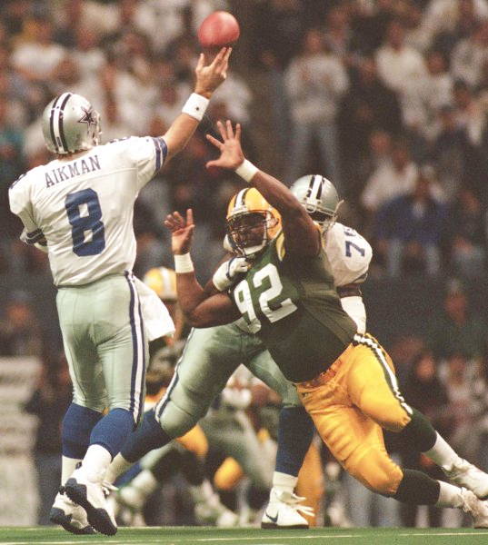 Reggie White of the Packers Rushing Troy Aikman of the Cowboys