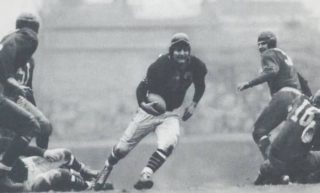 Sid Luckman, Chicago Bears quarterback takes off on a run.