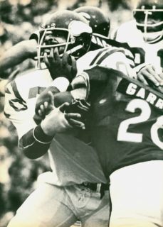 Vikings defensive lineman Jim Marshall has his facemask grabbed by Bears Carl Garrett