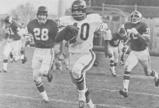 Bears runner Gale Sayers returns a kick-off against the Vikings 96 yards for a score in 1965