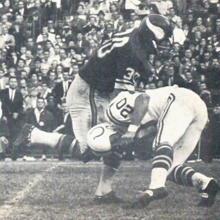 Bill Brown of the Vikings collides with the Colts Jerry Logan