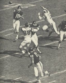 Bears QB Rudy Bukich gets the pass off to Mike Ditka as Rams lineman Deacon Jones applies pressure.