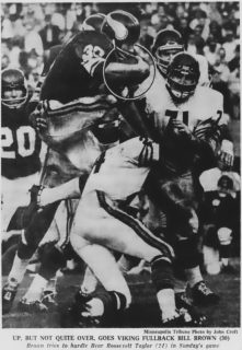 Roosevelt Taylor and Earl Leggett of the Bears stop Bill Brown of the Vikings