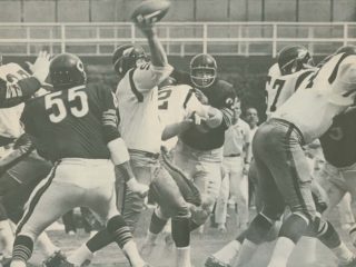 Redskins quarterback Sonny Jurgensen stand in the pocket while Chicago Bears defense closes in.