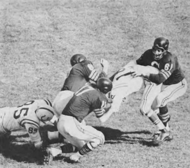 Johnny is sacked by the Bears defense Bill George, Doug Atkins and Richie Petitbon in 1962.