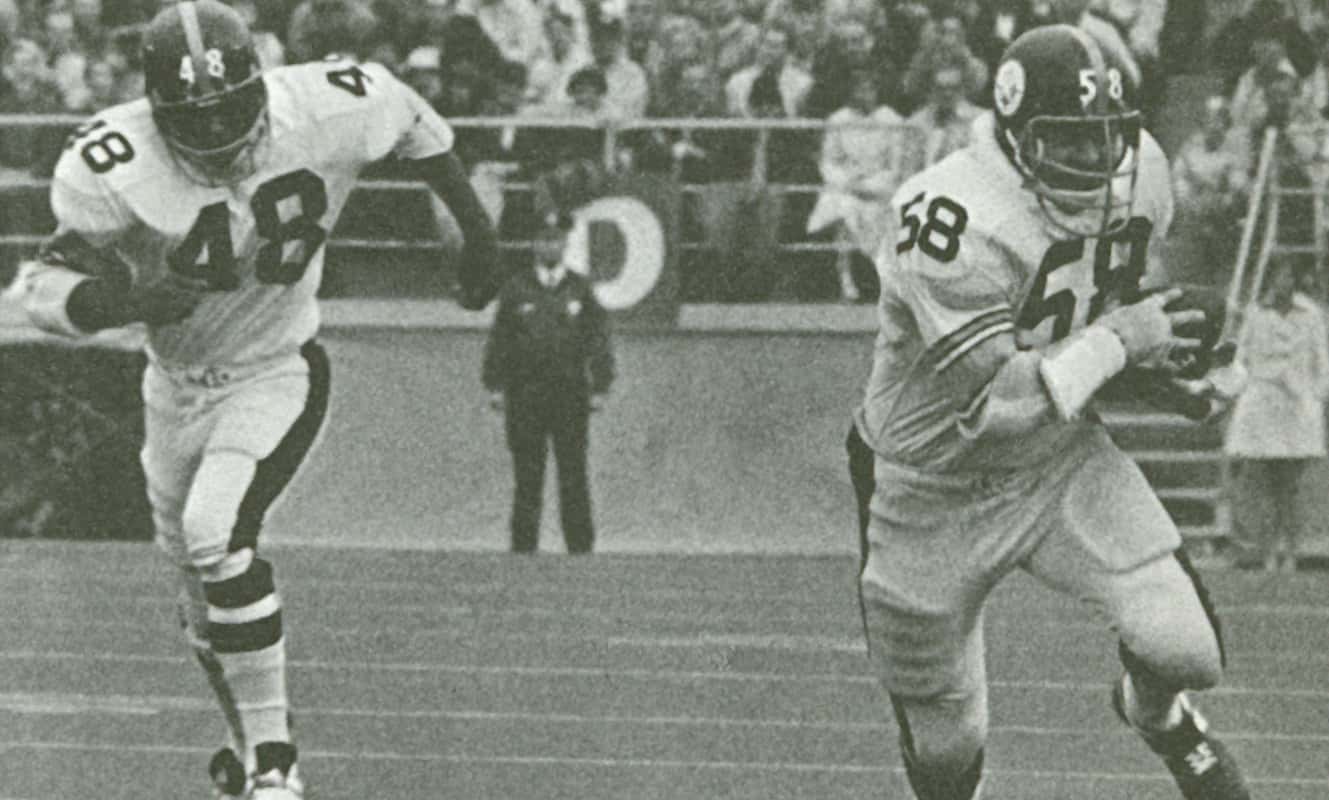 A black and white image of two Steelers, Chuck Allen and John Rowser, during a game in 1971.