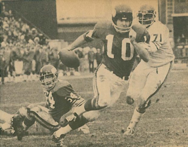Fran Tarkenton dashes with the ball in a black and white photo, evading Tony McGee in a mid-1970s NFL matchup.