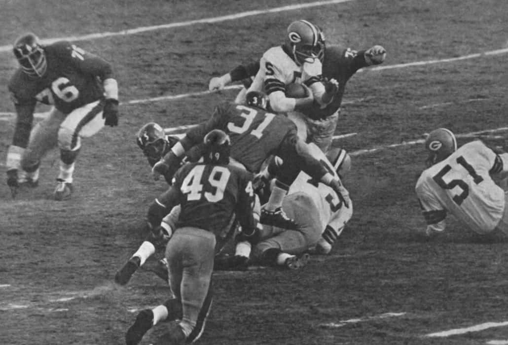 Paul Hornung runs through the NY Giants