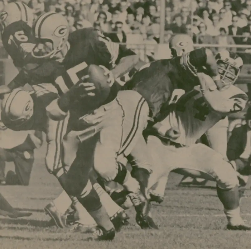 Bart Starr moves out while Merlin Olsen gets blocked.