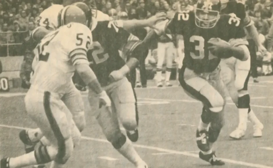 old picture from a magazine with Franco Harris carrying against the Cleveland Browns around 1972.