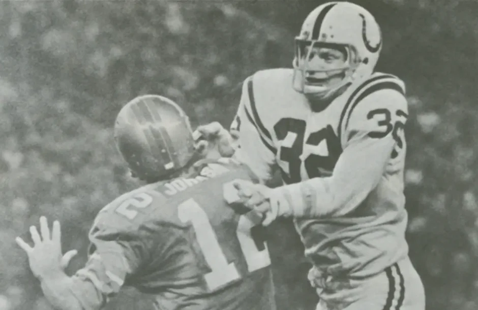 Black and white photo capturing Colts' Mike Curtis hitting Oiler quarterback Charley Johnson in a 1970s NFL matchup.