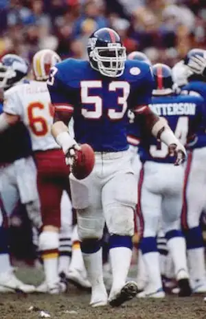 Harry Carson with Football