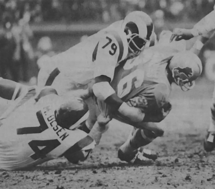 Rams Merlin Olsen and Coy Bacon bring down Lion runner Steve Owens - probably from the 1972 NFL season.