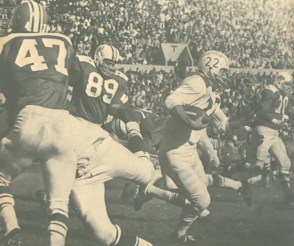 The Chargers Keith Lincoln was selected as an AFL All Star 5 times in his career. Here he breaks through the line of scrimmage in what might be to be the 1965 AFL All-Star Game. Featuring All Stars from the 1964 season, that would make the Patriot #89 Bob Dee and #47 in the foreground Pete Jaquess of Houston. Bill #70 in the background is Tom Sestak.