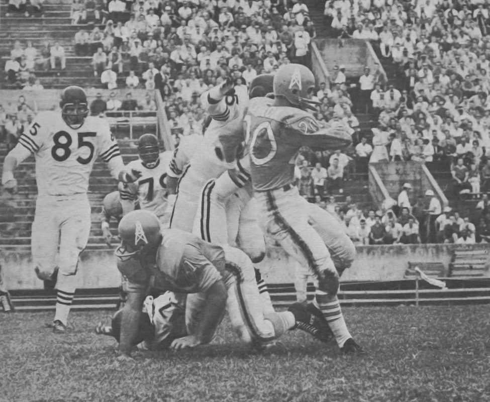 Billy Cannon carries against Oakland Raiders in 1960 AFL