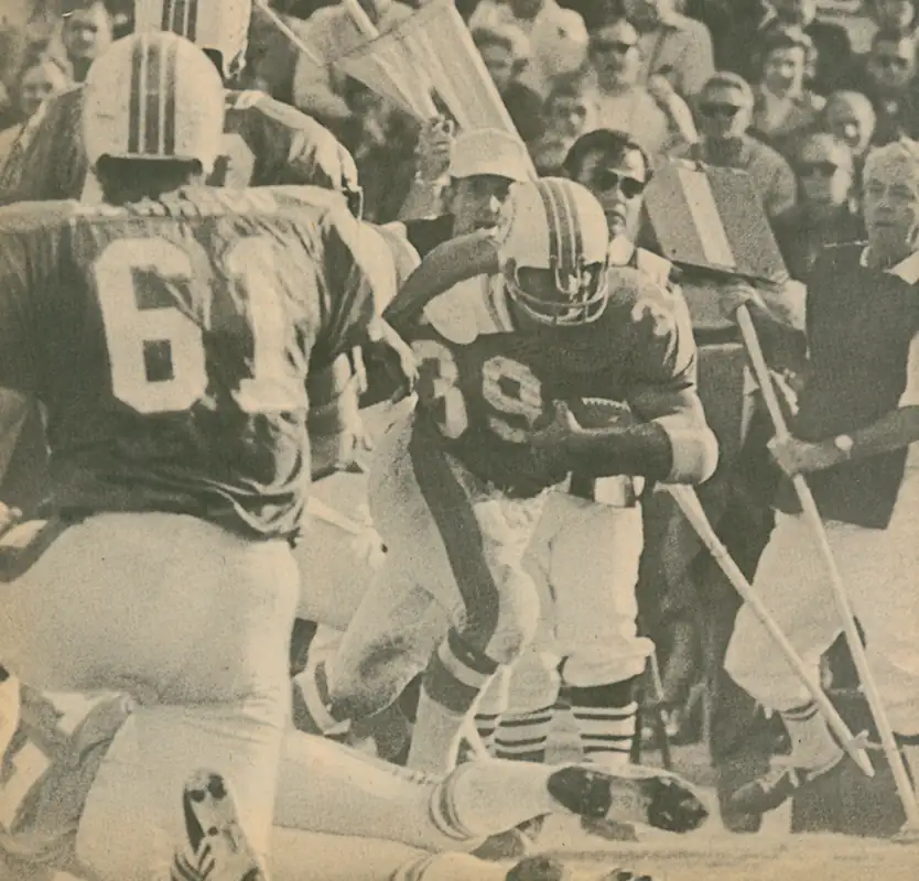 Larry Csonka gets rolling! In 1971 Csonka became the first Dolphin runner to go over 1,000 yards when he finished the year with 1051 yards on the ground with an impressive 5.4 YPC. That's center Bob DeMarco in the foreground. DeMarco had originally been with the St. Louis Cardinal for 9 seasons before joining the Dolphins in 1970.