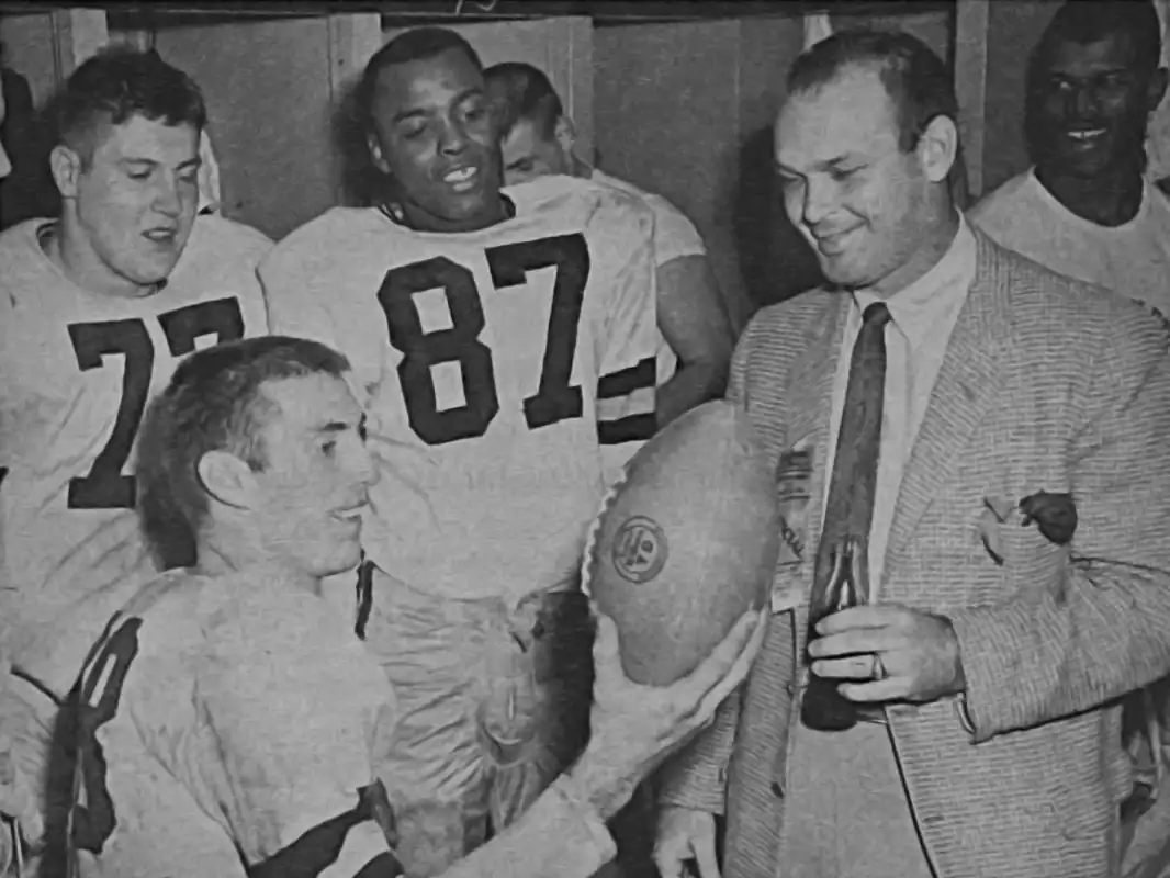 Iowa celebrates their 1957 Rose Bowl win over Oregon State. That's Alex Karras on the left, Jim Gibbons in the foreground, Frank Gilliam beside Karras and Head Coach Forest Evashevski with bottle of Coke. Karras and Gibbons to enjoy NFL careers with Detroit while Gilliam would play briefly in the CFL before joining Minnesota where he was a scout and personnel man for over 36 years.