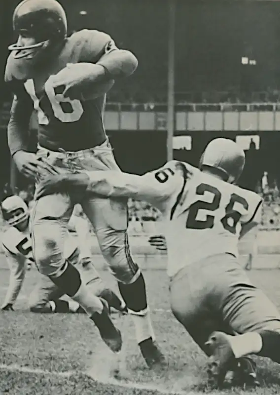 Frank Gifford Breaks the Tackle of Don Shula of the Redskins in 1957