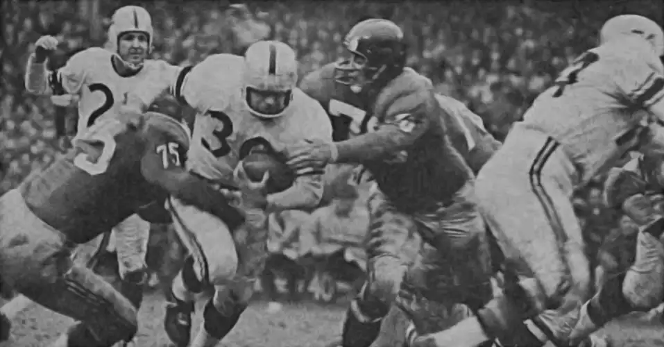 Vintage 1960s NFL action photo showing Steelers running back Tom Tracy being stopped by Giants legends Sam Huff and Jim Catcavage, with Bobby Layne visible in the background.