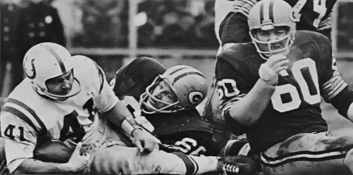 With identical 10-3-1 records at the close of the 1965 NFL season, the Packers and Colts were forced into a tie-breaker game for the NFL West Division. The Pack would win 13-10 in Sudden Death Overtime. Here, Colt Tom Matte (forced to play quarterback due to injuries to both Johnny Unitas and Gary Cuozzo) is stopped by Ray Nitschke and Lee Roy Caffey.