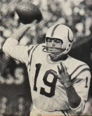 Vintage action photo of Hall of Fame quarterback Johnny Unitas throwing a pass for the Baltimore Colts during an NFL game.