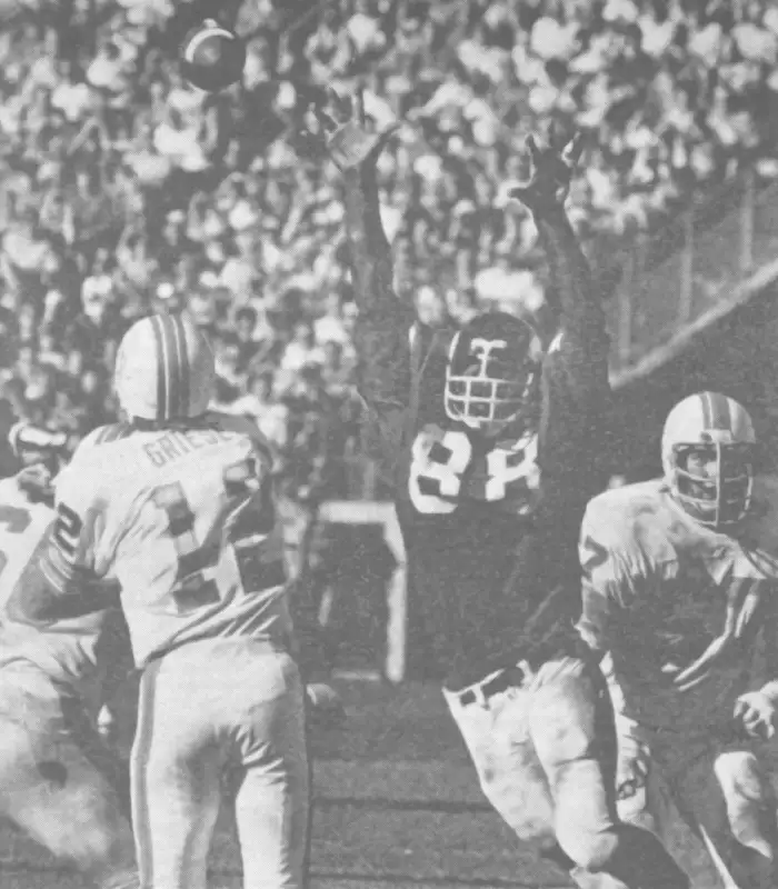 Dolphin quarterback Bob Griese gets the pass away as Viking Hall of Famer Alan Page gets up in his space in this early 1970s NFL action. That looks like guard Bob Kuechenberg he's just slipped past.