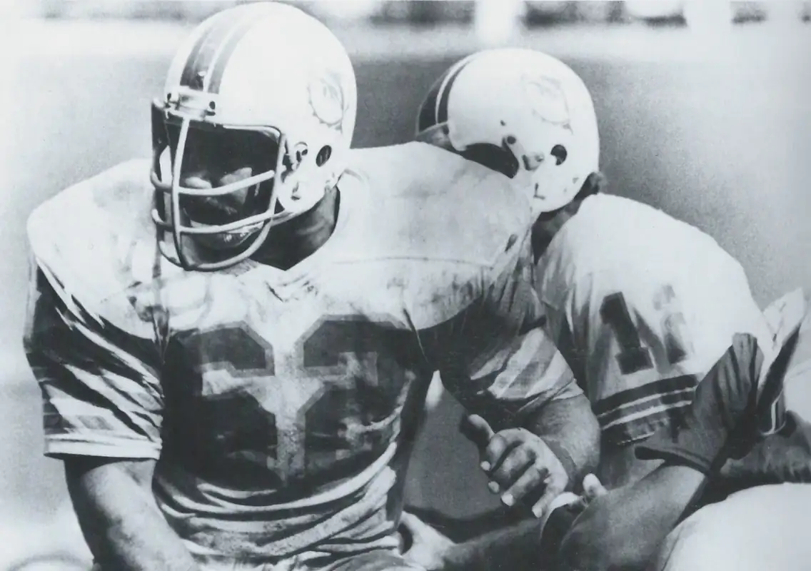 A pair of Miami Dolphin Hall of Famers from the 1970s era NFL - Center Bob Langer and Quarterback Bob Griese. Both started for the 1972 Dolphins, still the only team in NFL History to go undefeated all the way to a Super Bowl victory.
