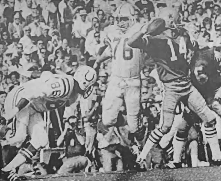Craig Morton has to hurry things as Roy Hilton and Fred Miller of the Baltimore Colts defense start to close in during a play from Super Bowl V in 1970.