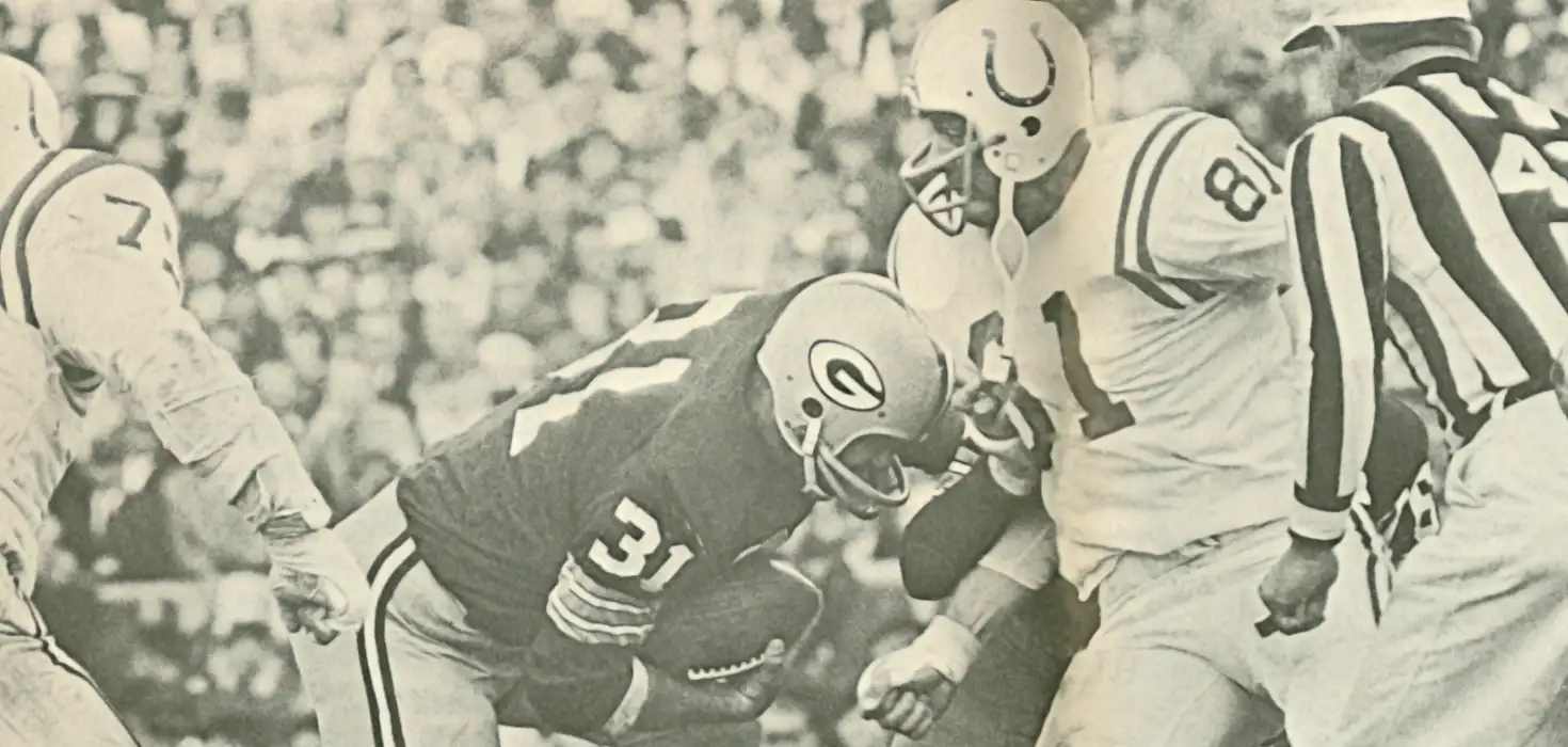 From the 1961 Packers-Colts game. Packer great Jim Taylor and Colts longtime vet Ordell Braase collide. Taylor had 82 yards an a touchdown in this 45-7 crushing of the Colts. Packer teammate Paul Hornung had 4.