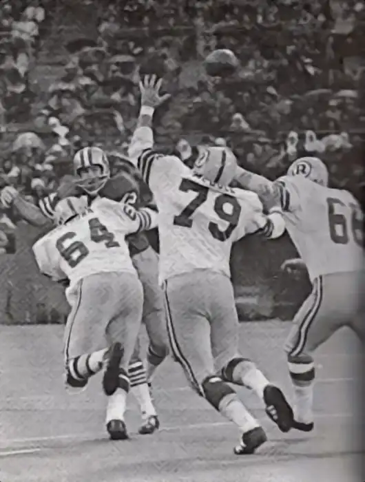 49er quarterback John Brodie gets this one off just in time as Redskin defenders Manny Sistrunk, Ron McDole and Myron Pottios have a little meet-up with him in this early 1970s NFL image.
