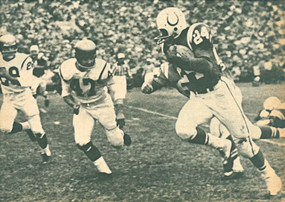 Colt Lenny Moore carries against the Washington Redskins in 1958. That's Redskin Dick James moving in to stop him. Word is this play was a 12-yard touchdown in the 35-10 Colts win.