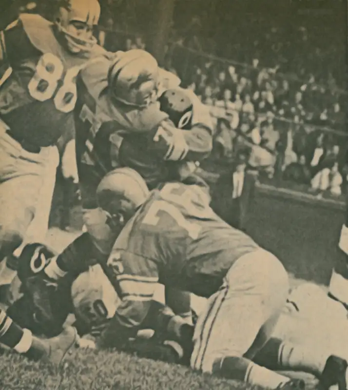 A Chicago Bears runner gets brought down by Detroit Lions defenders Alex Karras and Roger Brown. That looks like defensive end Sam Williams.
