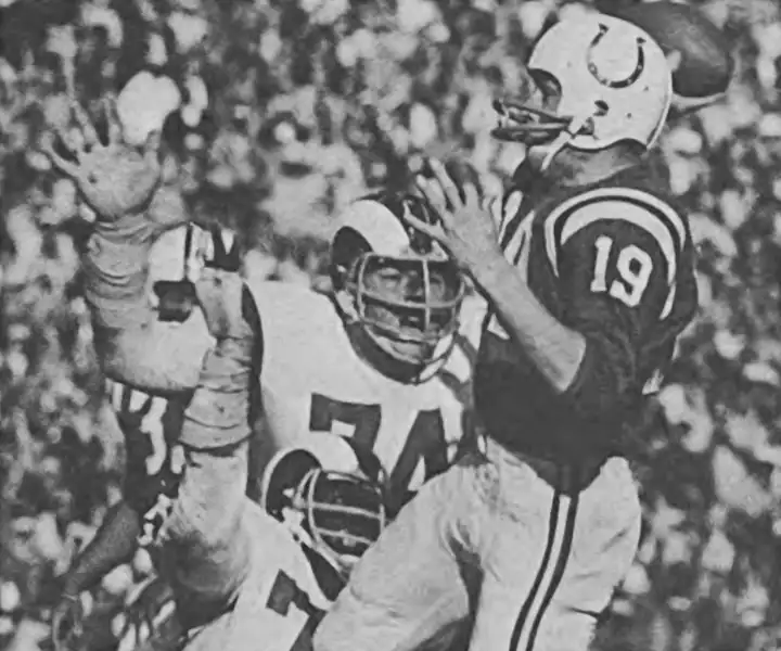 Vintage Rams-Colts from the late 1960s. Johnny Unitas looks downfield as Merlin Olsen and Deacon Jones apply some heavy pressure.