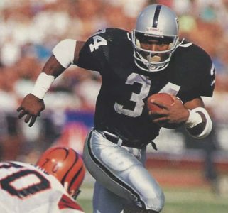 The Raiders Bo Jackson carries against the Bengals
