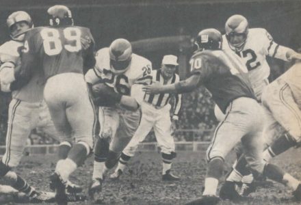 Giant defenders Sam Huff and Cliff Livingston move to stop Clarence Peaks of the Eagles