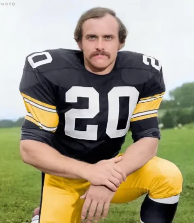 Picture of Steelers Rocky Bleier kneeling for a photgraph.